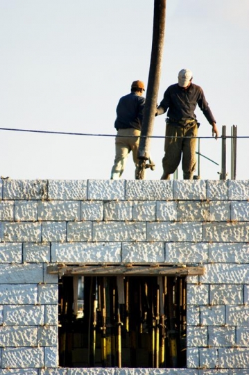 building under construction with workers