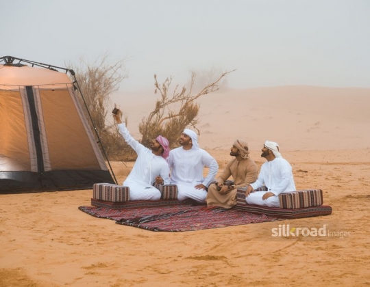 Man taking selfie with friends