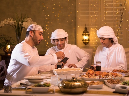 Man checking mobile phone with kids|-