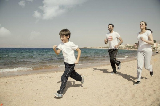 Family Running by the Sea