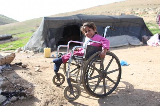 Cute crippled girl is playing with her brothers.