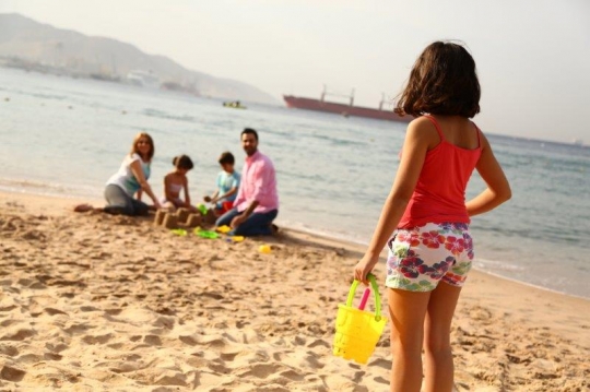 Family Having Fun By The Beach