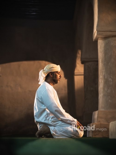 Old man paying in silence|-