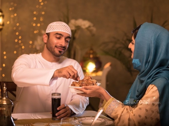 Husbad being served arabic sweets|-