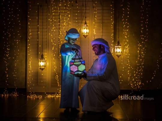 Father and son holding lantern|-
