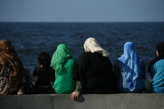 women sitting on a harbour of alexandria,egypt