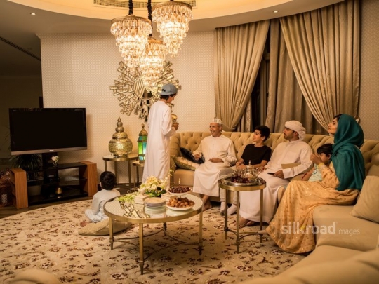 Teenager serving Arabic coffee|-