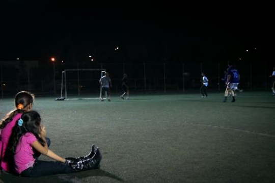 young men playing soccer on the sports field