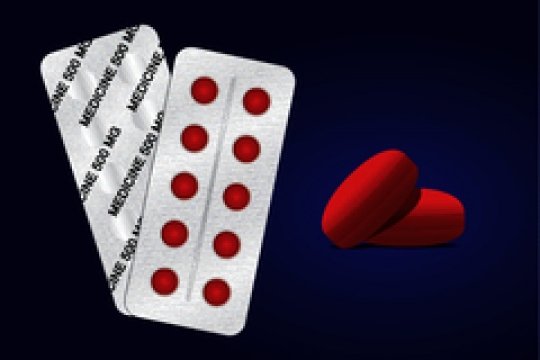 round pills in blister pack with red pills on blue