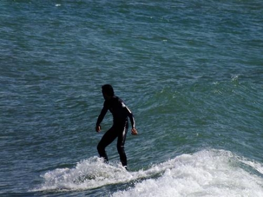 surfer on bouzinka beach,casablanca,morocco