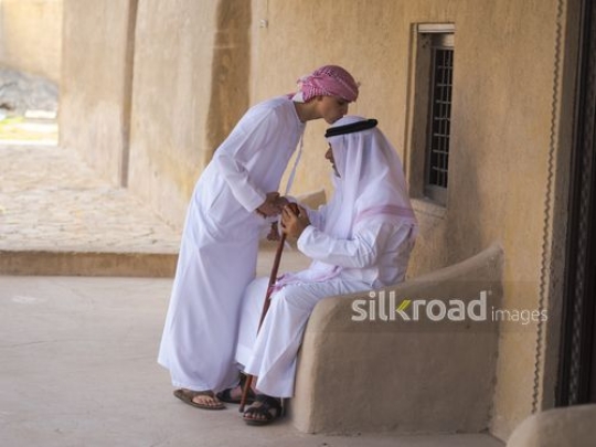 Boy kissing head of grandfather|-