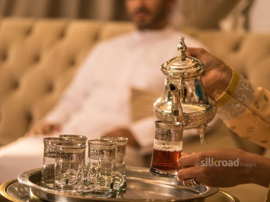 Wife serving Arabic tea|-