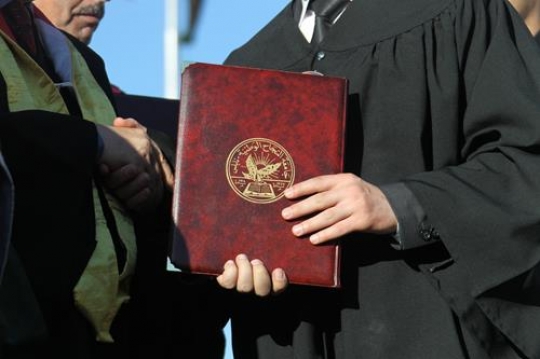 palestinian male holding a cer