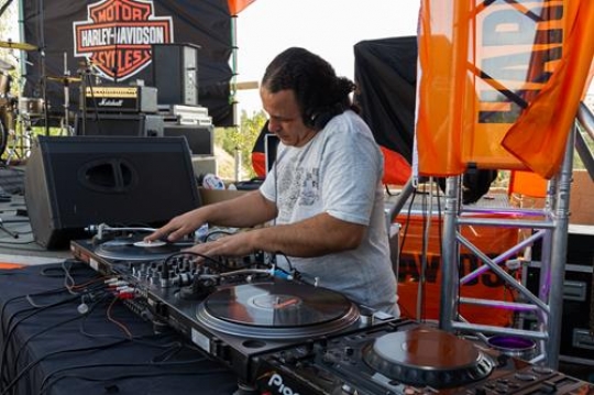 photo of adult dj working with his equipment