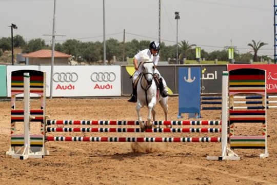 riding a horse in a competition