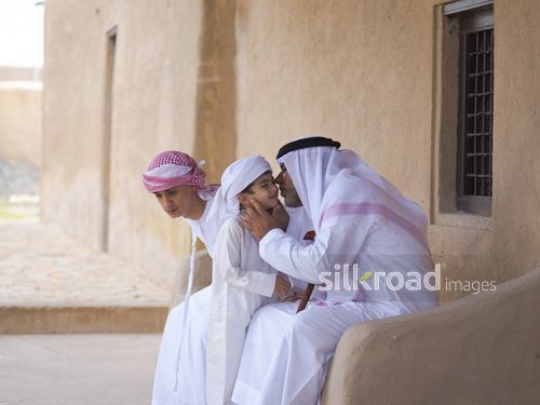 Grandfather kissing grandson|-