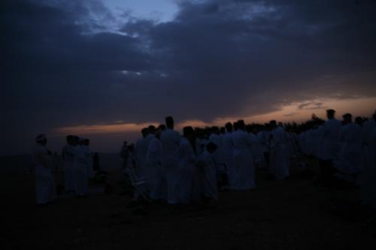members of the Samaritan community march atop Mount Gerizim, above the West Bank city of Nablus,