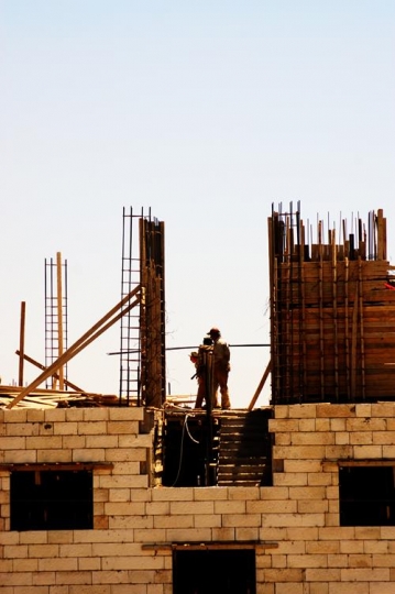 building under construction with workers