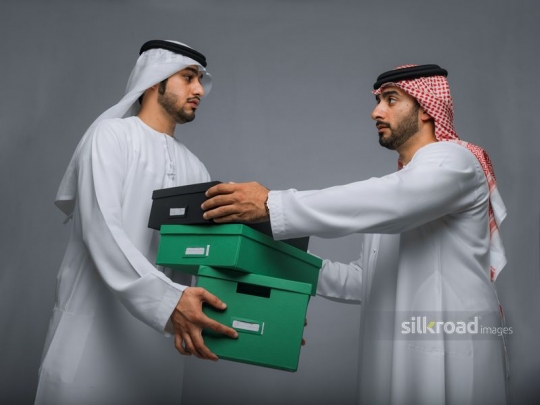 Employees helping each other out with the boxes|
