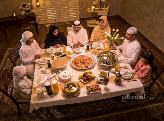 Family gathered around dining table|-