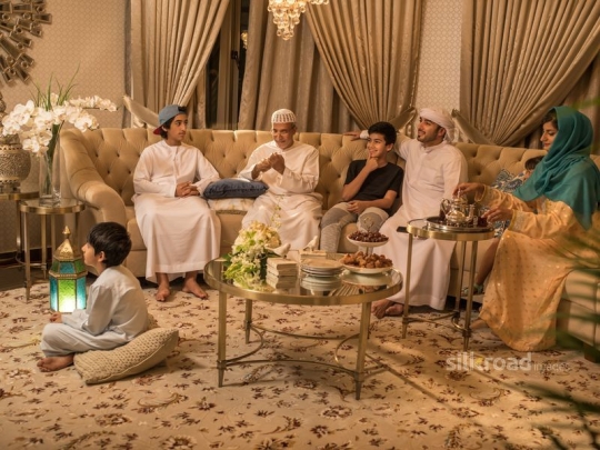 Family on sofa watching TV|-