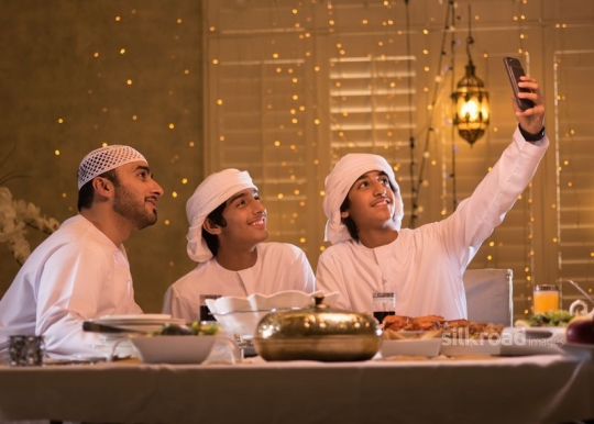 Boy taking selfie with family|-