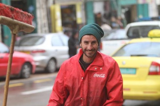 happy dust man with a sweeper looking at camera