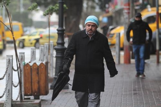 walking man with closed black umbrella