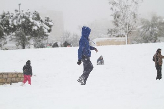 Fresh snow cover, at winter in Palestine, everbody happy and outside and play in the snow