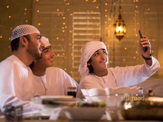 Boy taking selfie with family|-