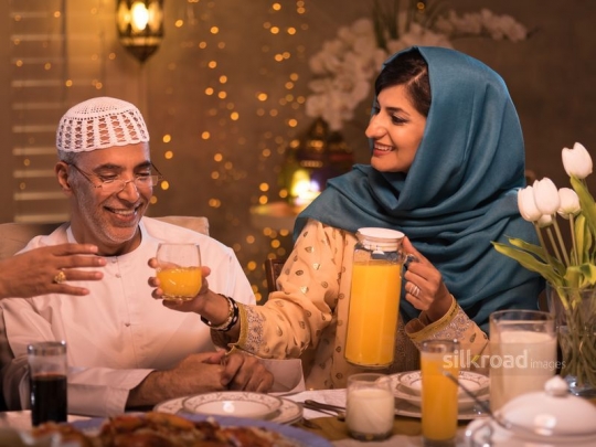 Woman serving orange juice|-