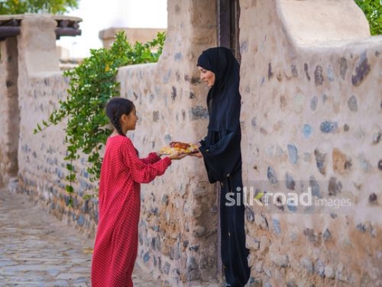 Woman receiving plate of food|-