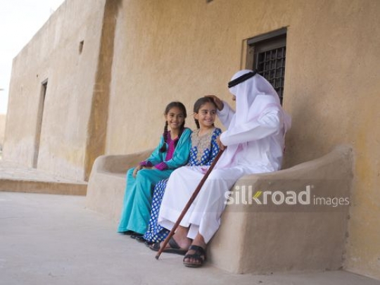 Grandfather caressing granddaughter|-