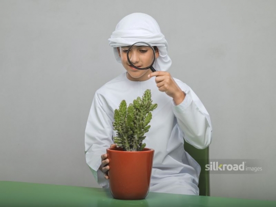 Little boy looking through his magnifier