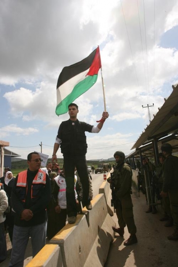 palestinian young man holding flag