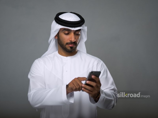 Arabian man typing messages