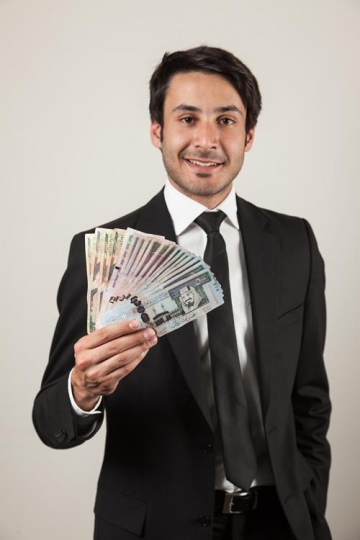 man hands holding saudi arabia riyal