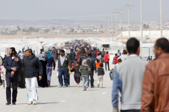 Crowd of people walling in main road in Zaatari refugee camp for Syrian refugees