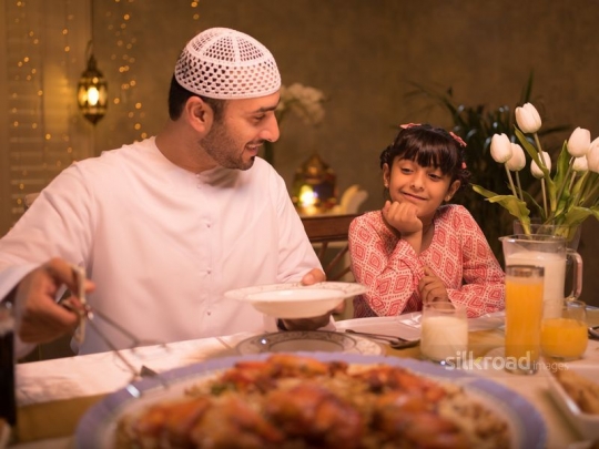 Father serving food to daughter|-