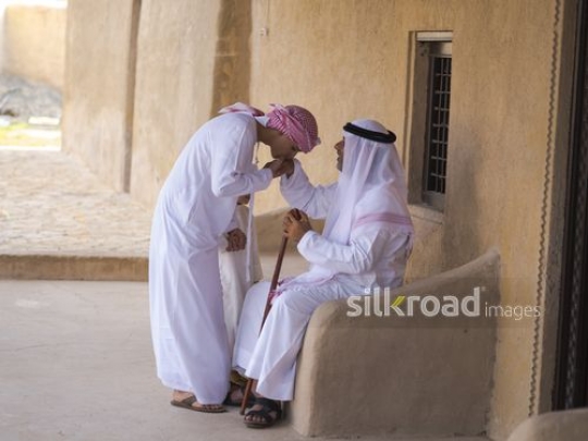 Teenager greeting grandfather|-