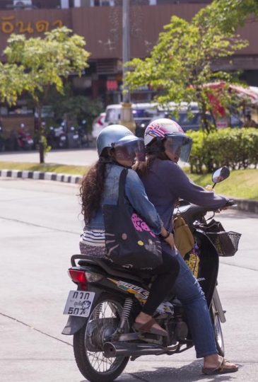 thai women riding a motorcycle