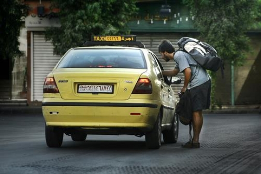 man talking to cab driver