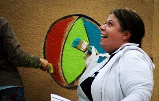 happiness woman painting the wall of kindergarten