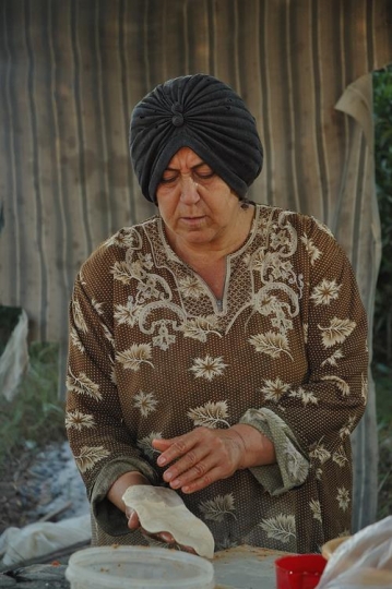 syrian woman kneading dough