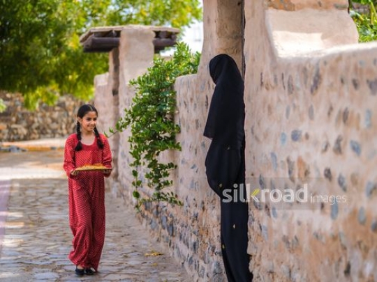 Girl walking towards woman in abaya|-