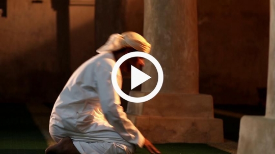 Old man praying inside the mosque