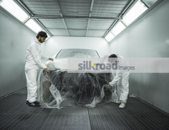 Workers wrapping the car |