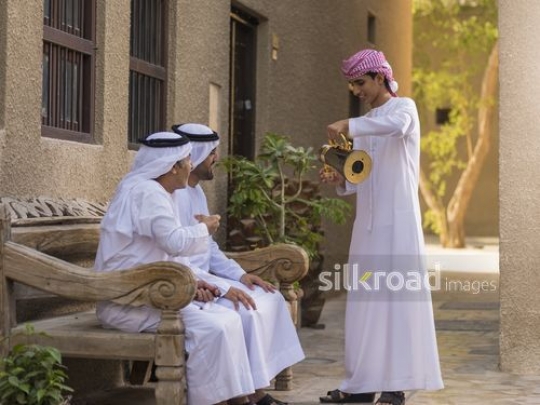 Arab son offering coffee to father and grandfather |-