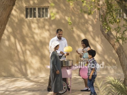 Arab kids taking cotton candy from the man|-