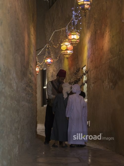 A middle eastern ramadan drink seller offering kids juice|-